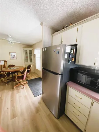 a kitchen with a refrigerator and a stove