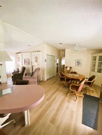 a living room with furniture a table and chairs
