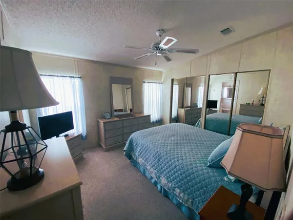 a bed room with a bed window and a chair