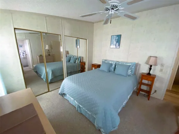 a bedroom with a bed and a mirror