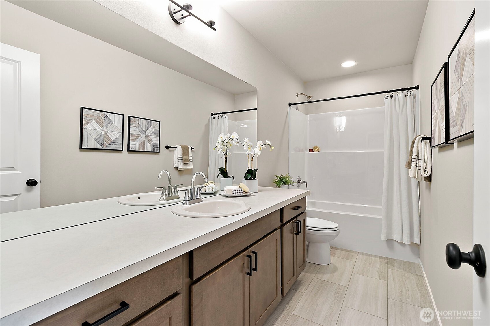 18510 Southeast 271st Place Covington, WA 98042 - Photo 21 of 23 a bathroom with a double vanity sink toilet mirror and bathtub