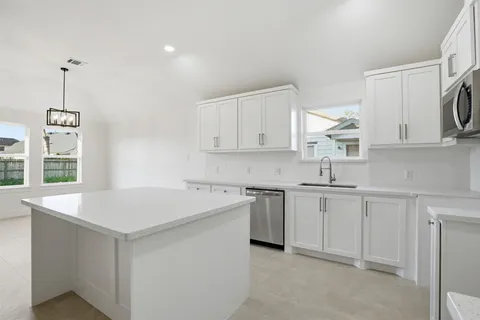 a kitchen that has a sink and a stove in it