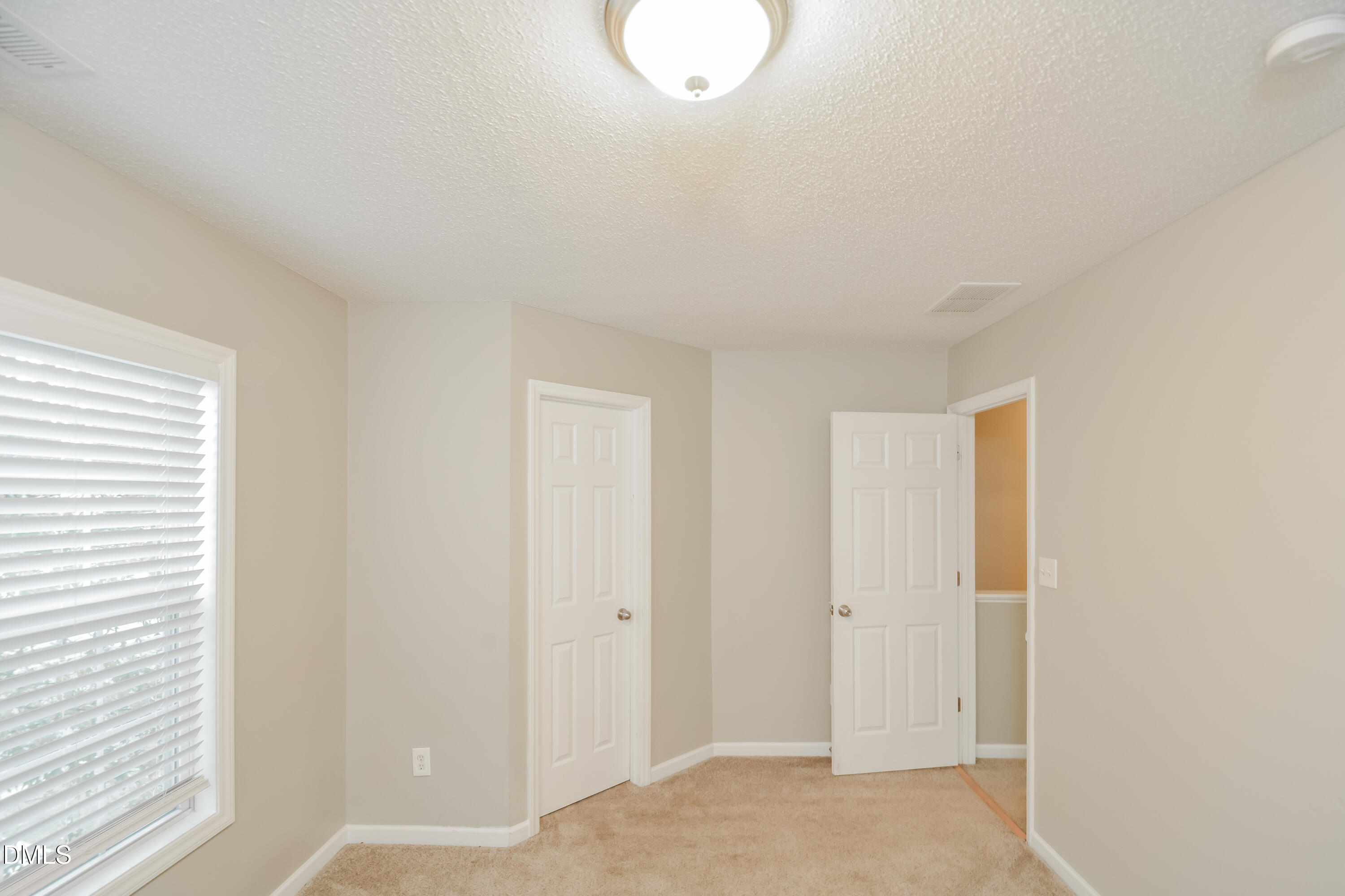 808 Woodside Park Lane Durham, NC 27704 - Photo 12 of 17 a view of a room with wooden floor and white walls