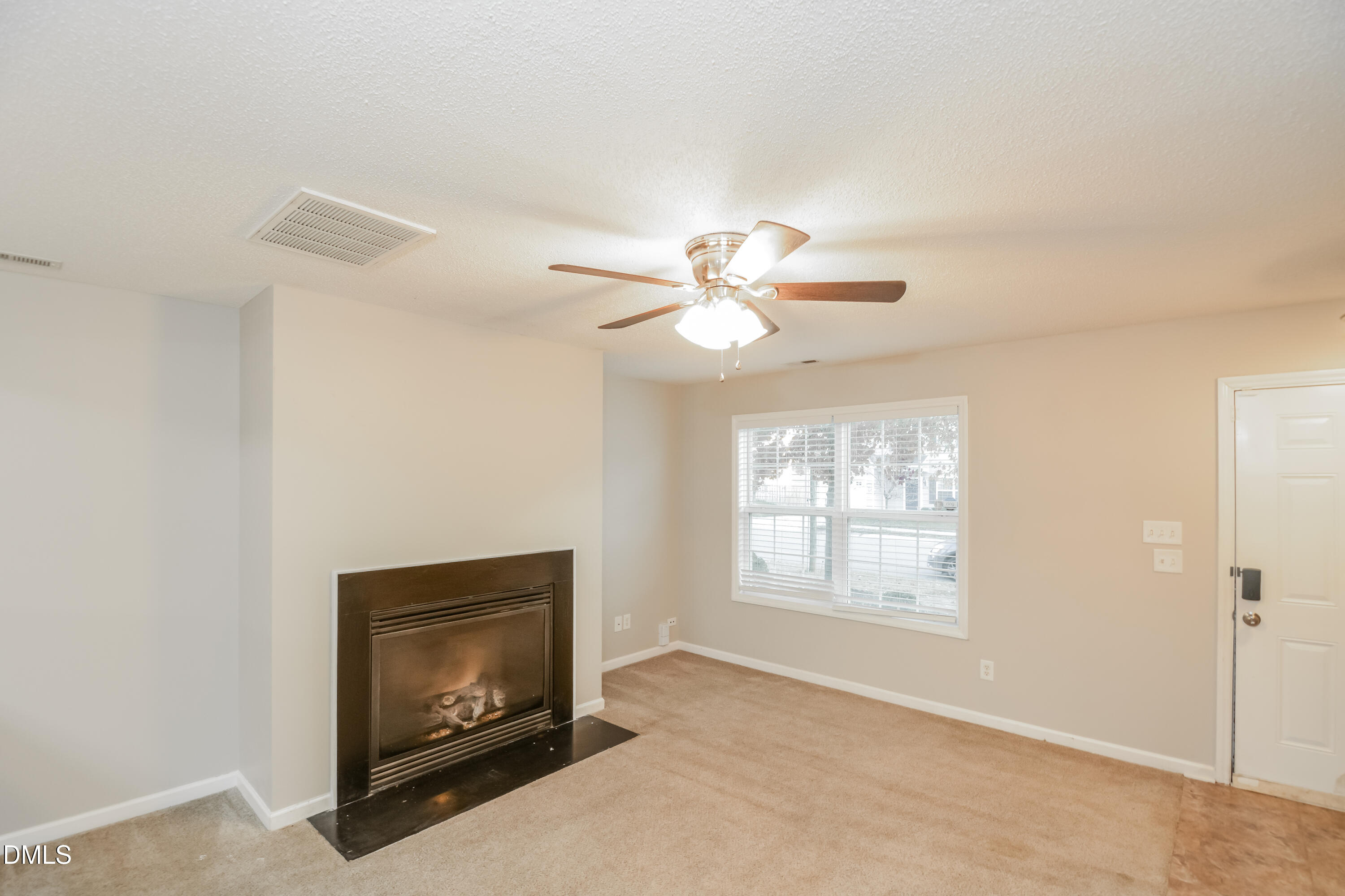 808 Woodside Park Lane Durham, NC 27704 - Photo 2 of 17 a view of an empty room with chandelier fan and fire place