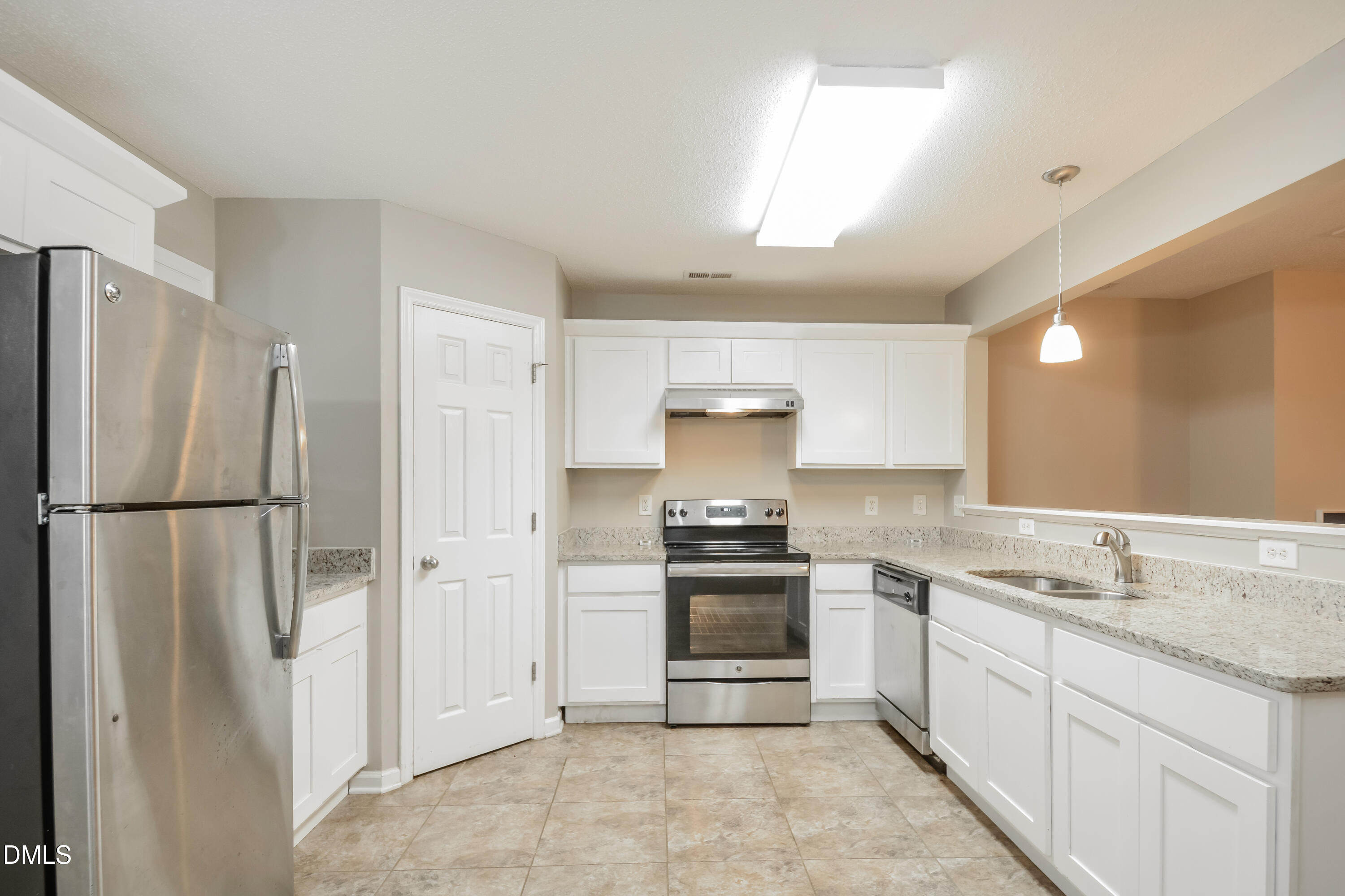 808 Woodside Park Lane Durham, NC 27704 - Photo 3 of 17 a kitchen with stainless steel appliances a refrigerator sink and stove