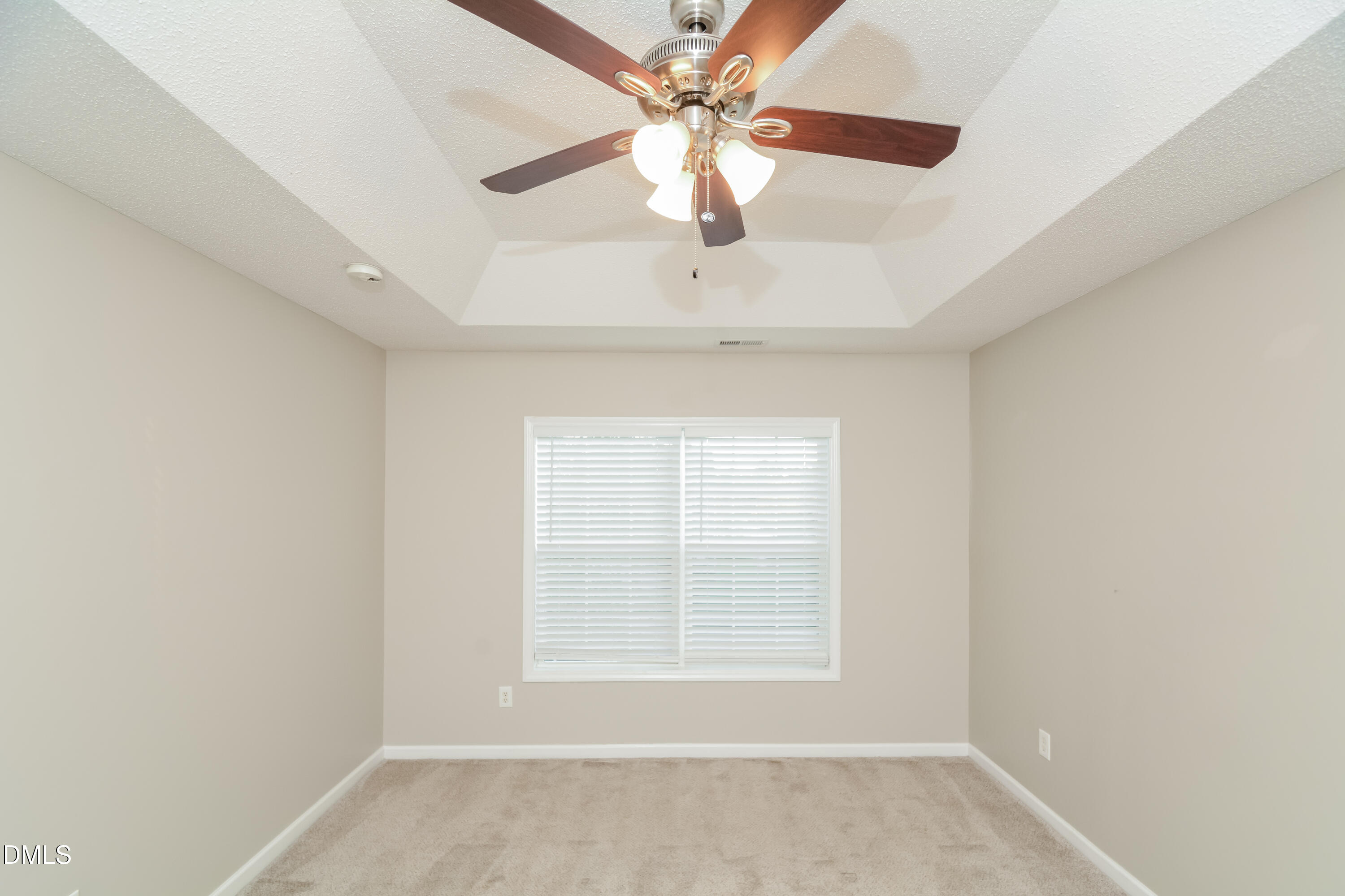 808 Woodside Park Lane Durham, NC 27704 - Photo 4 of 17 an empty room with a window and a fan