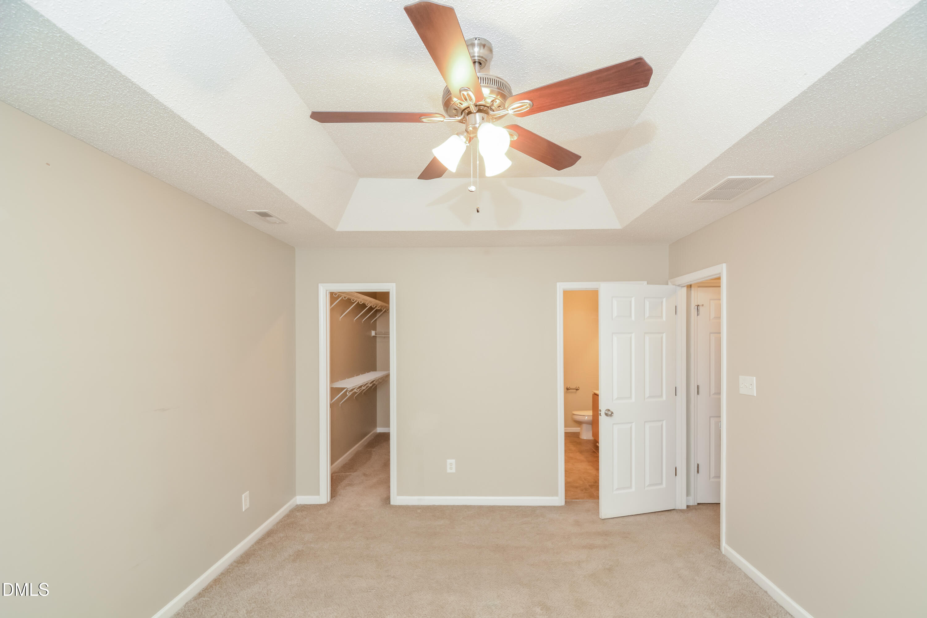 808 Woodside Park Lane Durham, NC 27704 - Photo 5 of 17 an empty room with closet and a ceiling fan