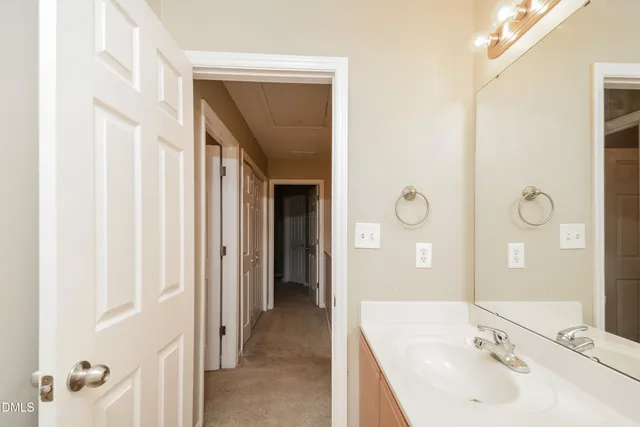 a bathroom with a sink a mirror and a shower