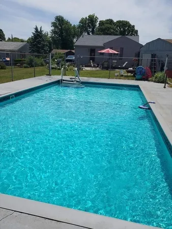 a aerial view of a house with swimming pool garden and patio
