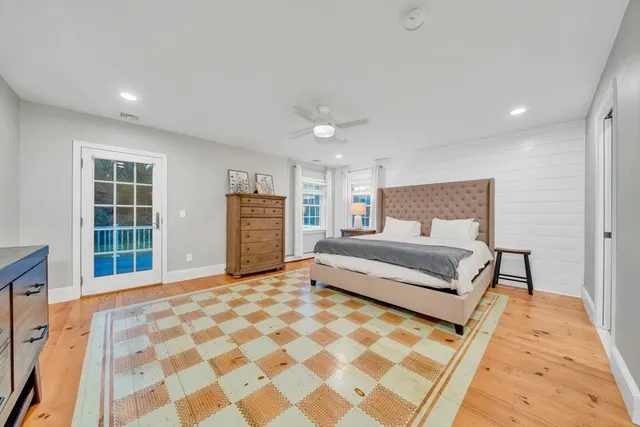 a bedroom with a large bed and a window