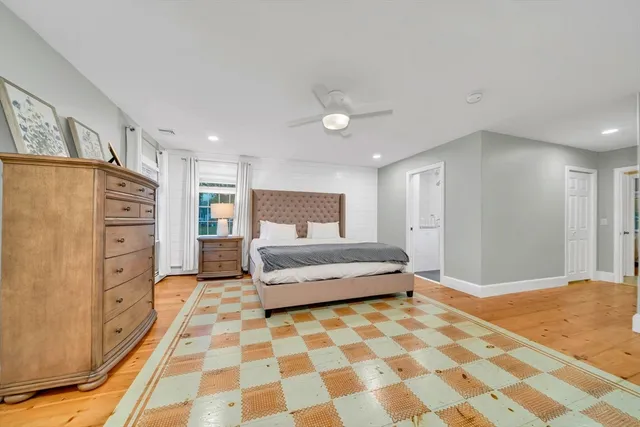 a spacious bedroom with a bed and a walk in closet