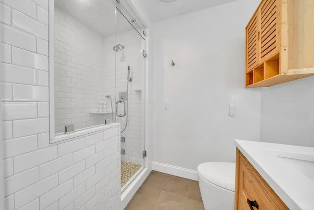 a bathroom with a shower and a toilet
