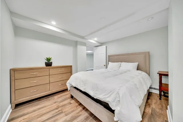 a bedroom with a bed and a dresser