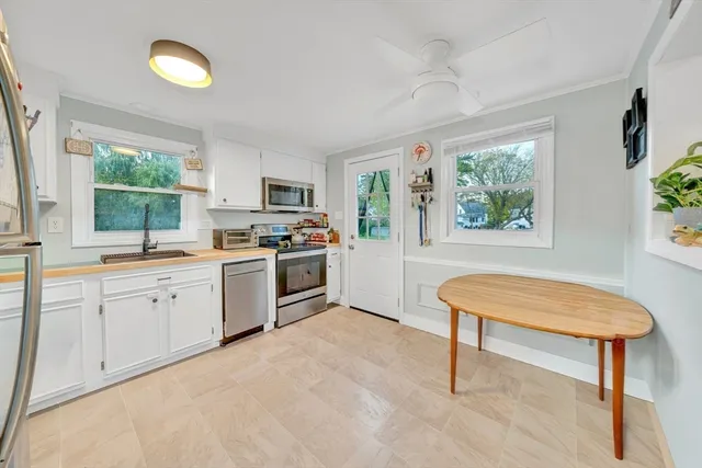 a kitchen with a stove a sink and a refrigerator