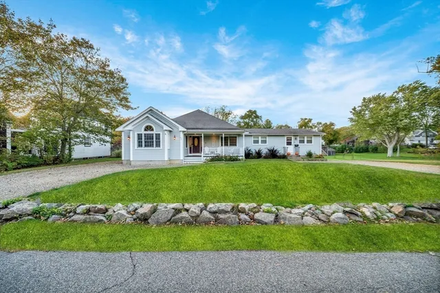 a front view of a house with a garden
