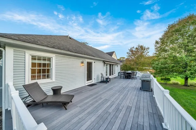 a backyard of a house with table and chairs