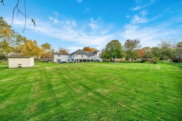 a view of a field of grass and trees