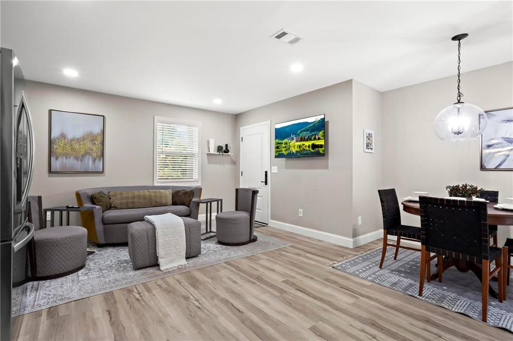 5750 Old Gordon Road Mableton, GA 30126 - Photo 16 of 31 a living room with furniture two window and a flat screen tv