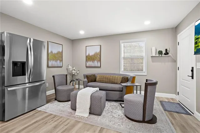 a living room with furniture windows and a flat screen tv