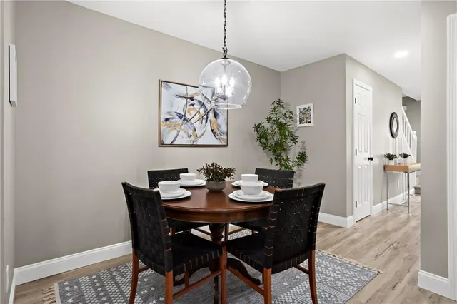 a view of a dining room with furniture wooden floor and a chandelier