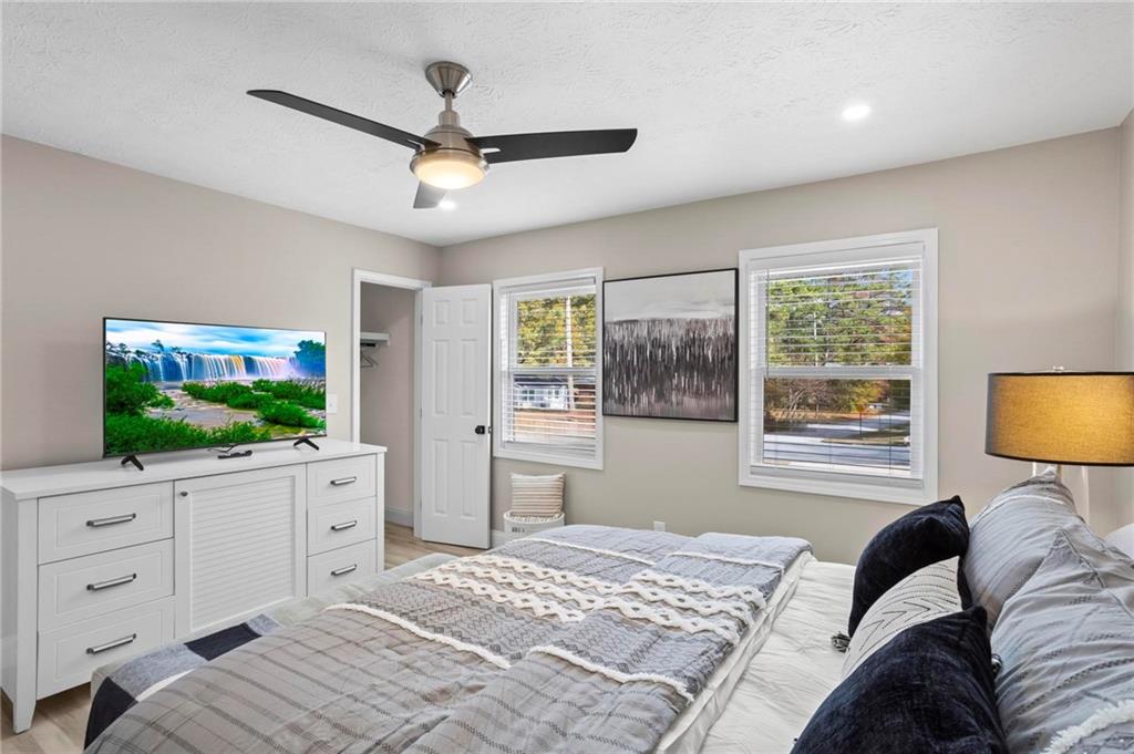 5750 Old Gordon Road Mableton, GA 30126 - Photo 25 of 31 a bedroom with a large bed and a flat screen tv