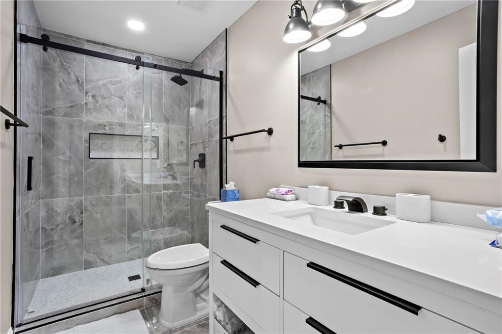 5750 Old Gordon Road Mableton, GA 30126 - Photo 26 of 31 a bathroom with a sink a toilet and shower