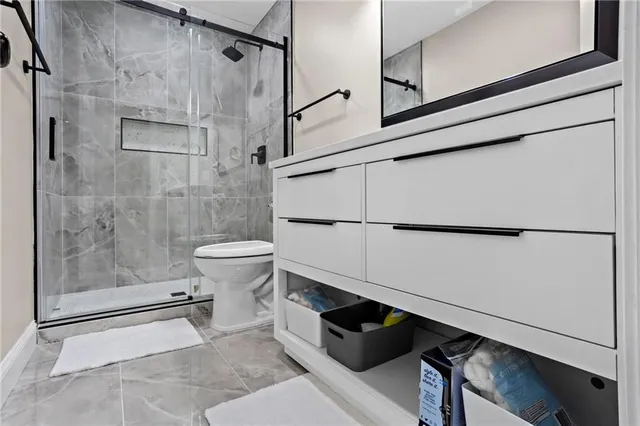 a bathroom with a toilet and a shower