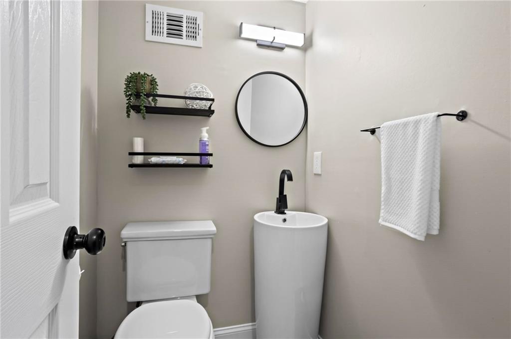 5750 Old Gordon Road Mableton, GA 30126 - Photo 29 of 31 a bathroom with a toilet a sink and a mirror