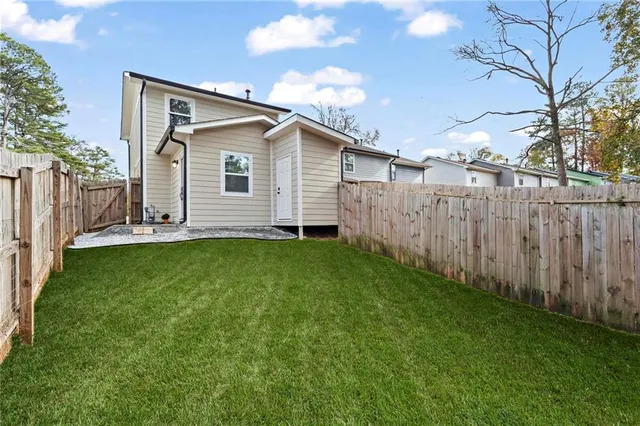 a view of a backyard with wooden fence
