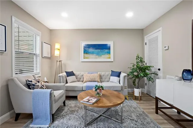 a living room with furniture and a potted plant