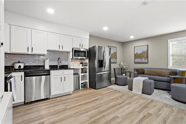 a kitchen with stainless steel appliances a refrigerator stove microwave and sink