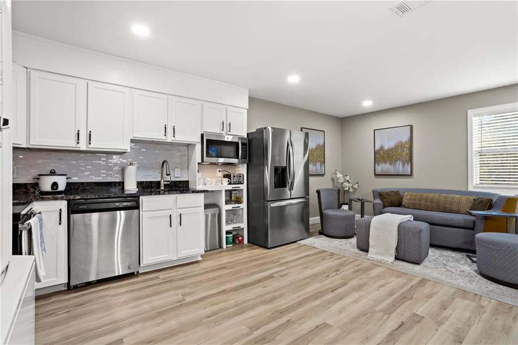 5750 Old Gordon Road Mableton, GA 30126 - Photo 9 of 31 a kitchen with stainless steel appliances a refrigerator stove microwave and sink