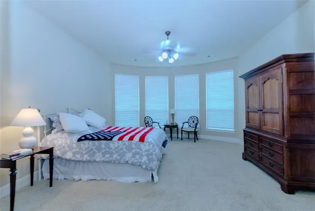 a spacious bathroom with a tub sink and mirror