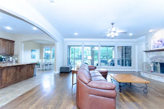 a living room with furniture fireplace and a large window