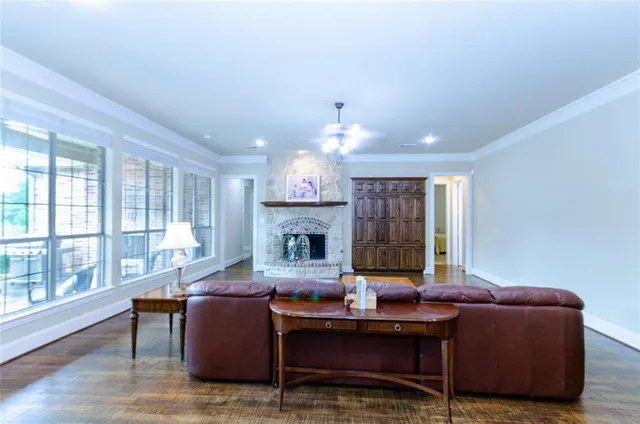 a living room with furniture a large window and a fireplace