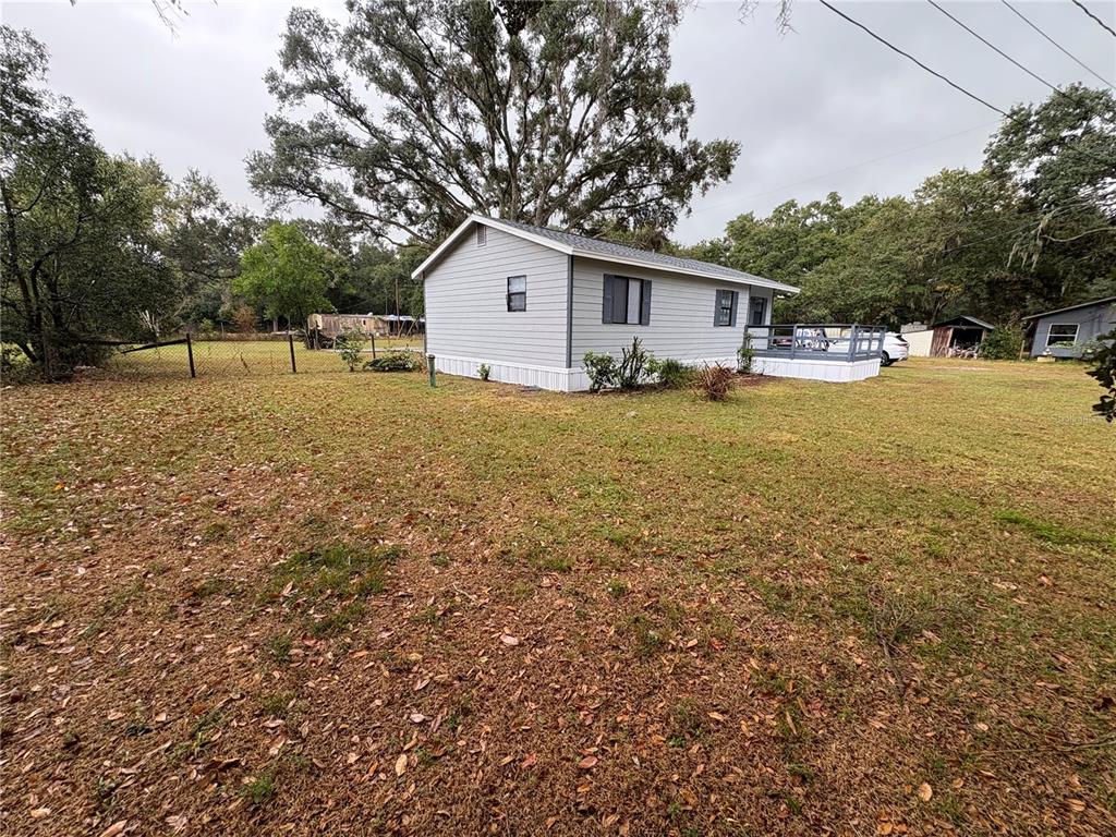 5206 Grimes Road Polk City, FL 33868 - Photo 13 of 17 a front view of house with yard and trees