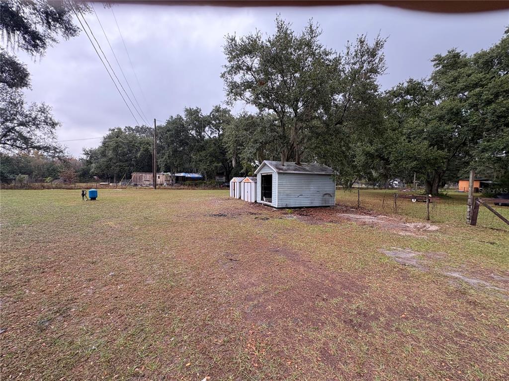 5206 Grimes Road Polk City, FL 33868 - Photo 17 of 17 a backyard of a house with table and chairs