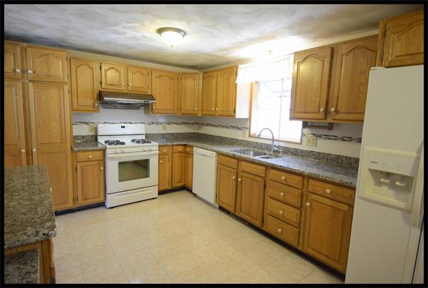 19 Long Meadow Road Chelmsford, MA 01824 - Photo 18 of 19 a kitchen with stainless steel appliances granite countertop a stove a sink dishwasher a refrigerator and cabinets with wooden floor