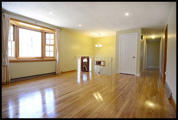19 Long Meadow Road Chelmsford, MA 01824 - Photo 3 of 19 a view of a livingroom with wooden floor and staircase