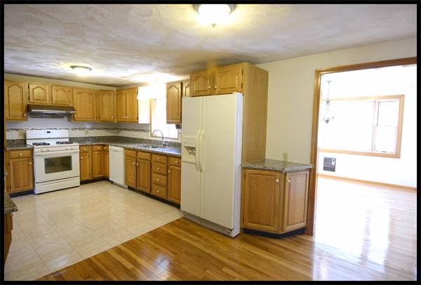 19 Long Meadow Road Chelmsford, MA 01824 - Photo 4 of 19 a kitchen with stainless steel appliances granite countertop a refrigerator a sink a stove and oven