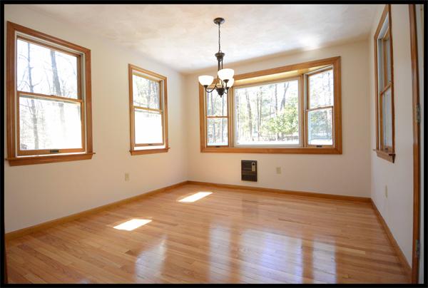 19 Long Meadow Road Chelmsford, MA 01824 - Photo 6 of 19 an empty room with wooden floor and windows
