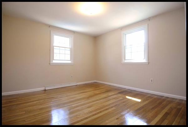 19 Long Meadow Road Chelmsford, MA 01824 - Photo 9 of 19 an empty room with wooden floor and windows