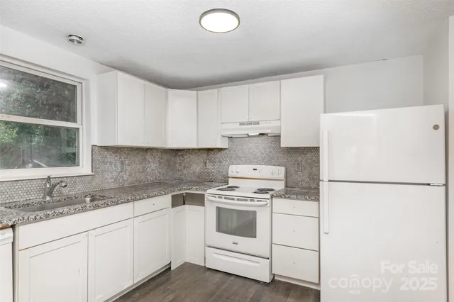 a kitchen with a white cabinets and white appliances