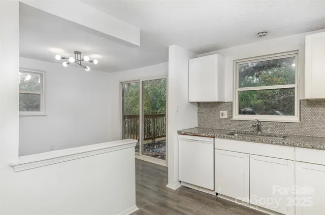 a bathroom with a granite countertop sink a large mirror and a window