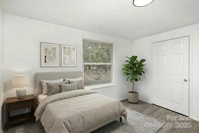 a bedroom with a bed and potted plant