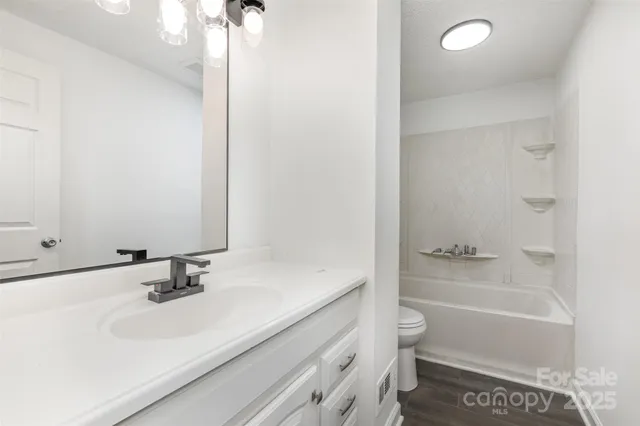 a bathroom with a sink a toilet and a bathtub