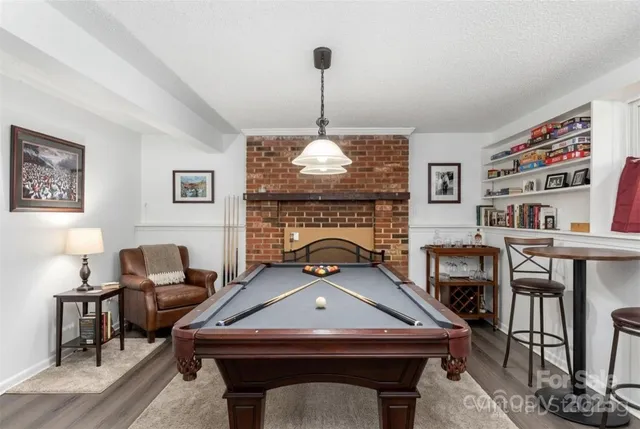 a living room with furniture a fireplace and wall paintings