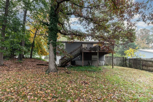 front view of a house with a large tree