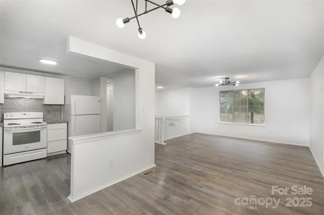 a view of a kitchen with wooden floor and a sink