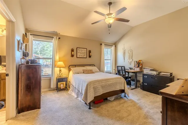 a spacious bedroom with a bed and a chandelier